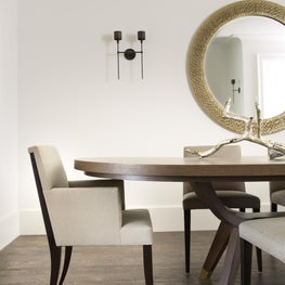 Clean sleek transitional contemporary dining room with white walls, wood table