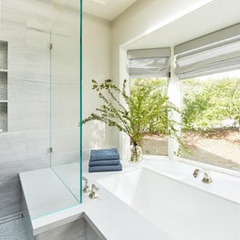 Cloud White Master Bathroom with Soaking Tub and Frameless Glass Shower