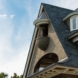 Oceanfront Elevation Curved Shingle Balcony and Covered Porch with Slate Roof