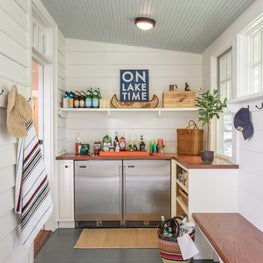 Lake Michigan Cottage: Converted, enclosed porch becomes "sand room" and bar.