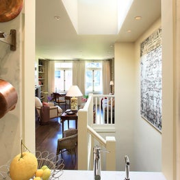 Open kitchen window into living area with skylight