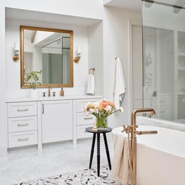 The geometric patterned tile surrounding the bath is distinctly modern but we love that its gentle tones remind us of timeless terrazzo.