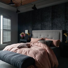 Moody Principal Bedroom with Upholstered Walls