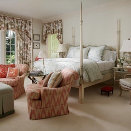 This master bedroom is awash in soft colors and prints.