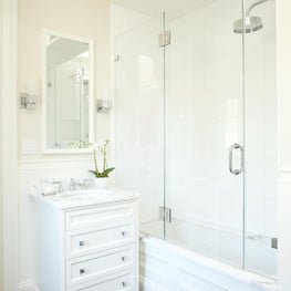 Clean, white bathroom with herringbone tile floor