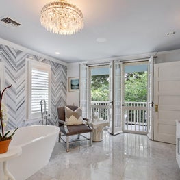 Master Bathroom detail of double doors opening to second floor balcony 