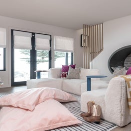 Chic, cozy, and complete with an under the stairs reading nook, this kiddos lounge is ready for endless after-school fun.