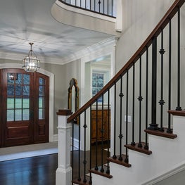Elegant Foyer with Arched Custom Front Door by viola interior design