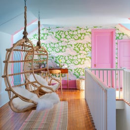 Suspended woven basket chairs in children's bedroom