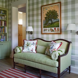Three Barn Farm Breakfast Room. Settee in chic English Country style farmhouse with green gingham wallpaper.