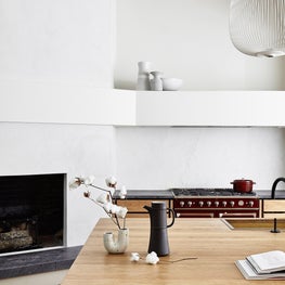 Soulful Home Kitchen with Island, Cooking Range and Fireplace