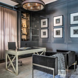 Portfolio: A sleek home office with soft gray walls and custom drapery.