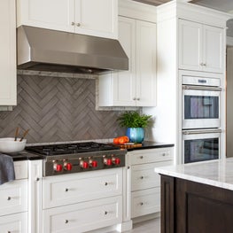 Kitchen with view of range and hood