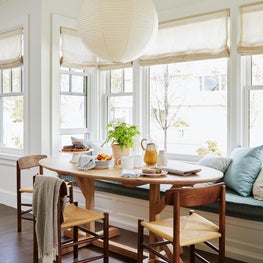 Coastal blue and white breakfast area with mid century furniture