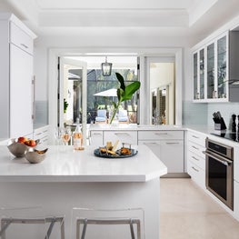 The white contemporary kitchen blends form and function.