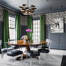 Dining Room with paneled walls and round dining table