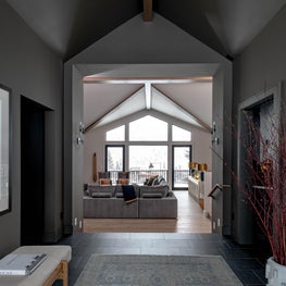 Enormous windows, a vaulted ceiling, and gorgeous beams funnel one’s attention inward towards the stunning views outside the great room windows.