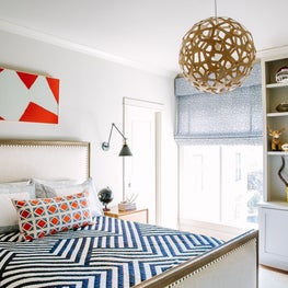 Boys room with modern textiles, library sconces and sphere chandelier