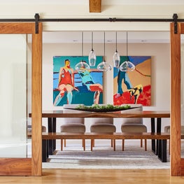 Fun Dining Room with vibrant hues from local artist Gail Ragains’ painting 