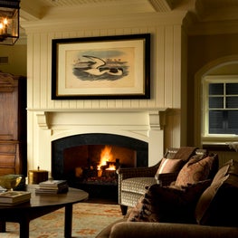 Living Room White Wood Paneled Fireplace and Painted Beams