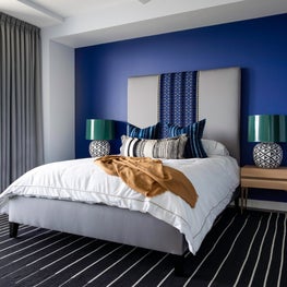 Portfolio: Colorful and Sophisticated Bedroom with Blue Wall and Black Rug