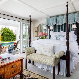 This four-poster bed is a focal point for the bedroom's design.