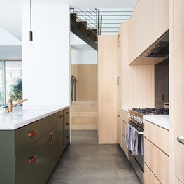 Kitchen, View to Stairs, in Oak, Marble, Leather, and Brass with Concrete Floors
