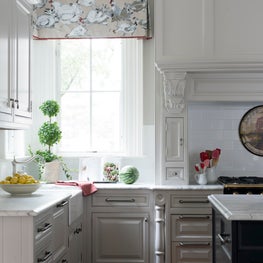 A Traditional White Kitchen with Rustic Wood Floors