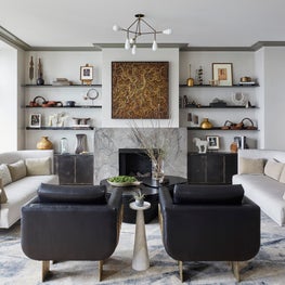 Steel Cabinetry and Custom Finishes frame this Living Room