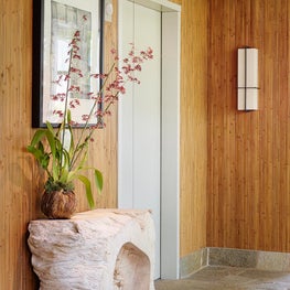 Penthouse Apartment | Entry with bamboo wall covering and stone floor