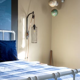 Portfolio: A nautical bedside lamp and hanging planet decor in the corner of a boys bedroom in Houston, Texas