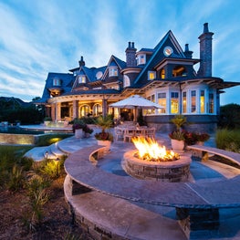 Shingle Style Oceanfront House at Dusk with Fire Pit