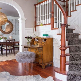 Entryway Foyer and Staircase with Animal Hide and Antique Secretary