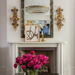 Glamour fireplace with large mirror and sconces