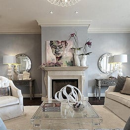 Designed for a young couple, this sleek, contemporary living room meets their request for an open space for entertaining, with a serene color palette, and fabrics resilient enough for their pets. 