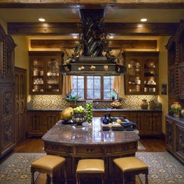 This deliciously inviting Tuscan-styled kitchen provides an extraordinary work space for the owner’s most robust culinary creations.  