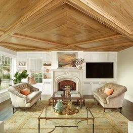 Living Room with Stone Mantle and Butternut Wood Ceiling and Beams
