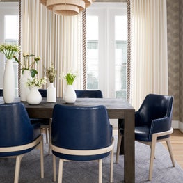 Layers of texture create an inviting atmosphere in this dining room. Blue leather adds a touch of bold sophistication.