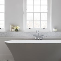Luxury master bathroom featuring freestanding bath, carrera marble 