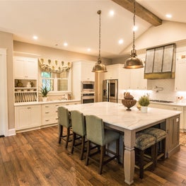 Green-themed kitchen with an island