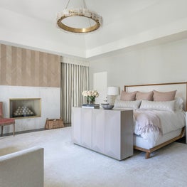 Portfolio: A Maya Romanoff wood veneer over a fireplace in a blush master bedroom in Houston.