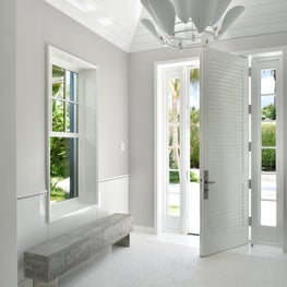 Pure white lines in the buttery pavilion foyer of a Palm Beach surf cottage