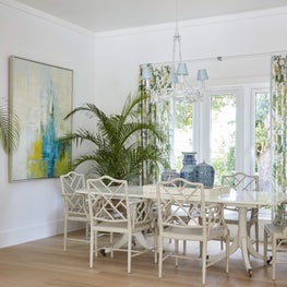 Tropical modern dining room with antique blue and white ceramic China collection