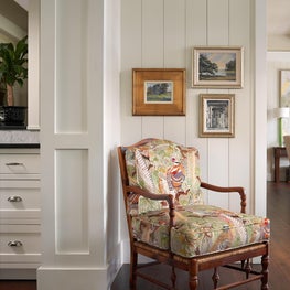 An antique armchair sits perfectly in front of updated millwork - mixing old and new.