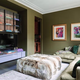 Palm Green Media Room with modern art and fur ottoman 