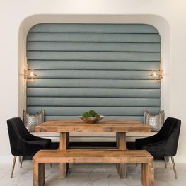 The breakfast nook has distinctive Kravet wall fabric & Regina Andrews sconces.