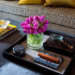Hair on hide coffee table close-up with purple tulips
