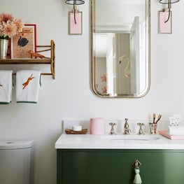 Children's bathroom with green vanity and custom wall sconces