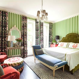 Striped colorful eclectic bedroom in coral, blue and green