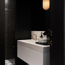 Moody hematite tile, graphic floor, and barely pink marble. Park Ave powder room